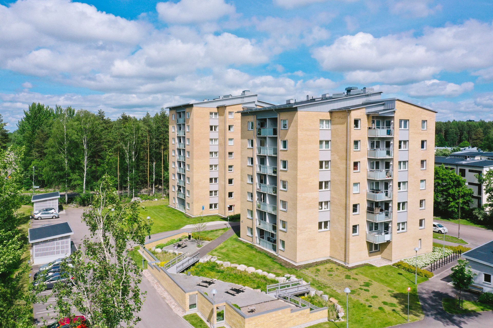 Två punkthus i ljust tegel, 7 våningar, grönytor med bänkar