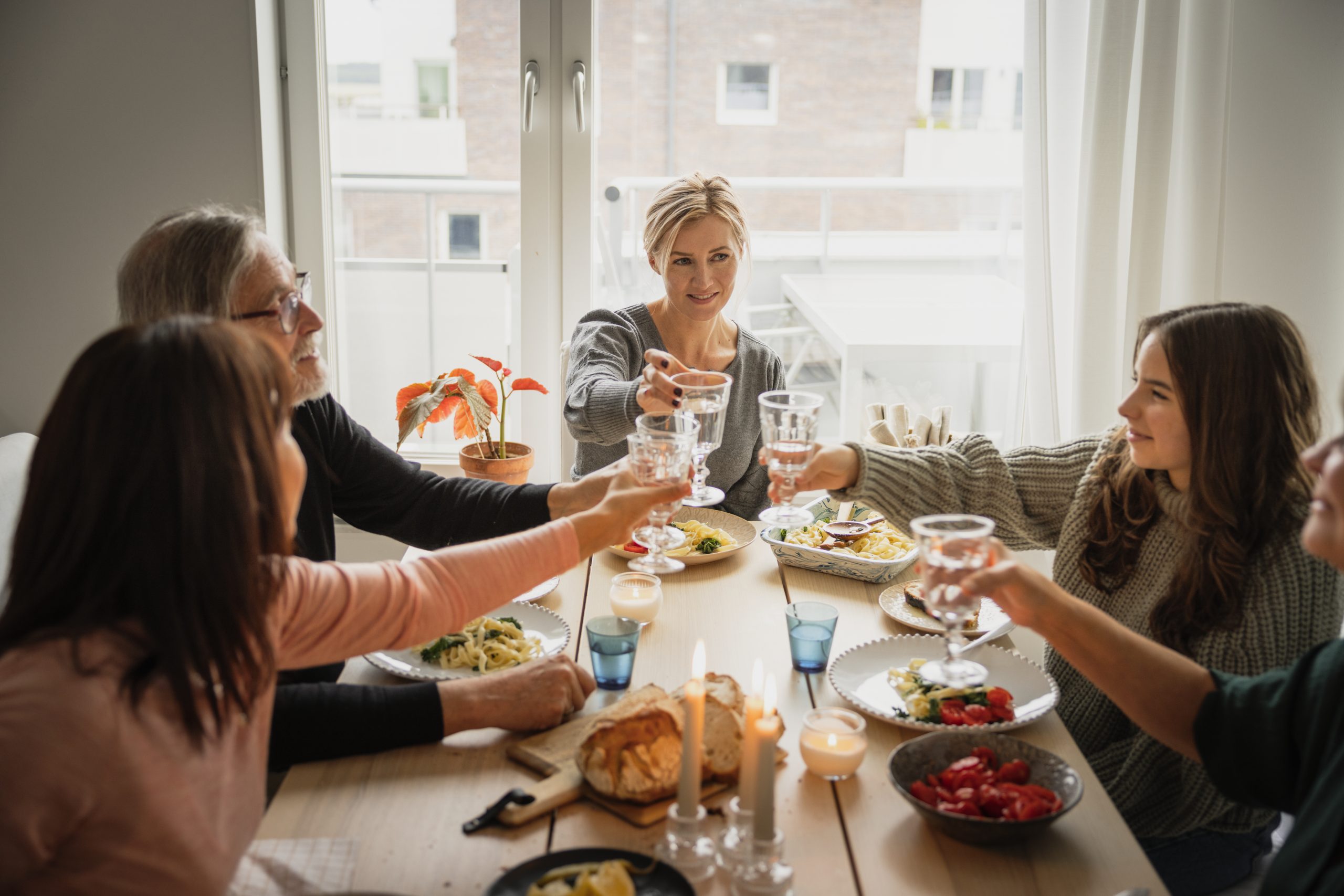 Grupp människor äter middag tillsammans.